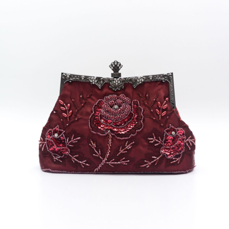 Avondtasje in de stijl van een clutch met kralenborduurwerk en bloemenmotief, gemaakt van stof.