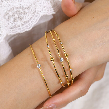 Eenvoudige ronde, waterdichte damesarmband van roestvrij staal met gouden strass-steentjes. 2